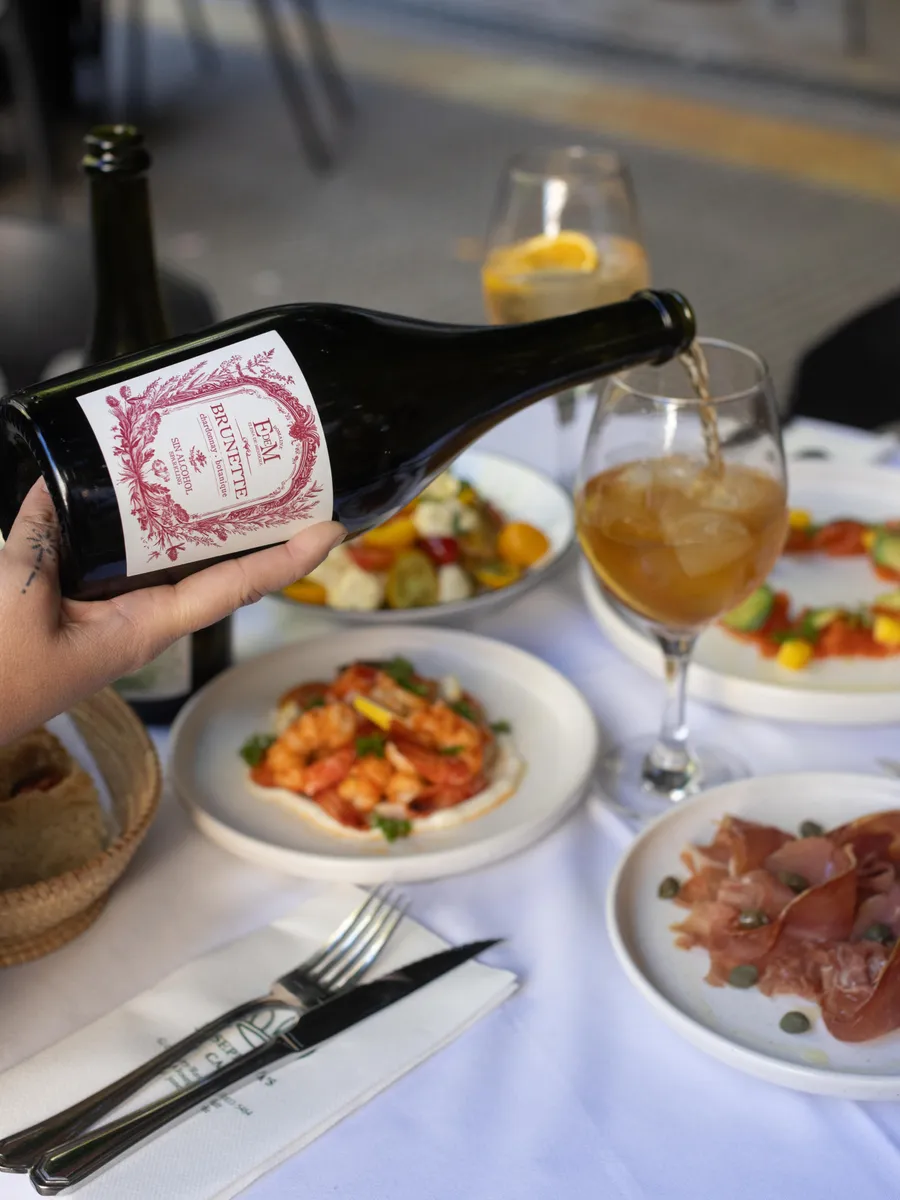 BRUNETTE being poured at a table set with small dishes