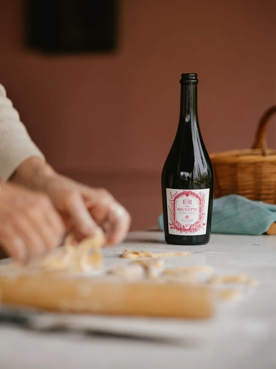 Bottle of BRUNETTE on a table while fresh pasta is made