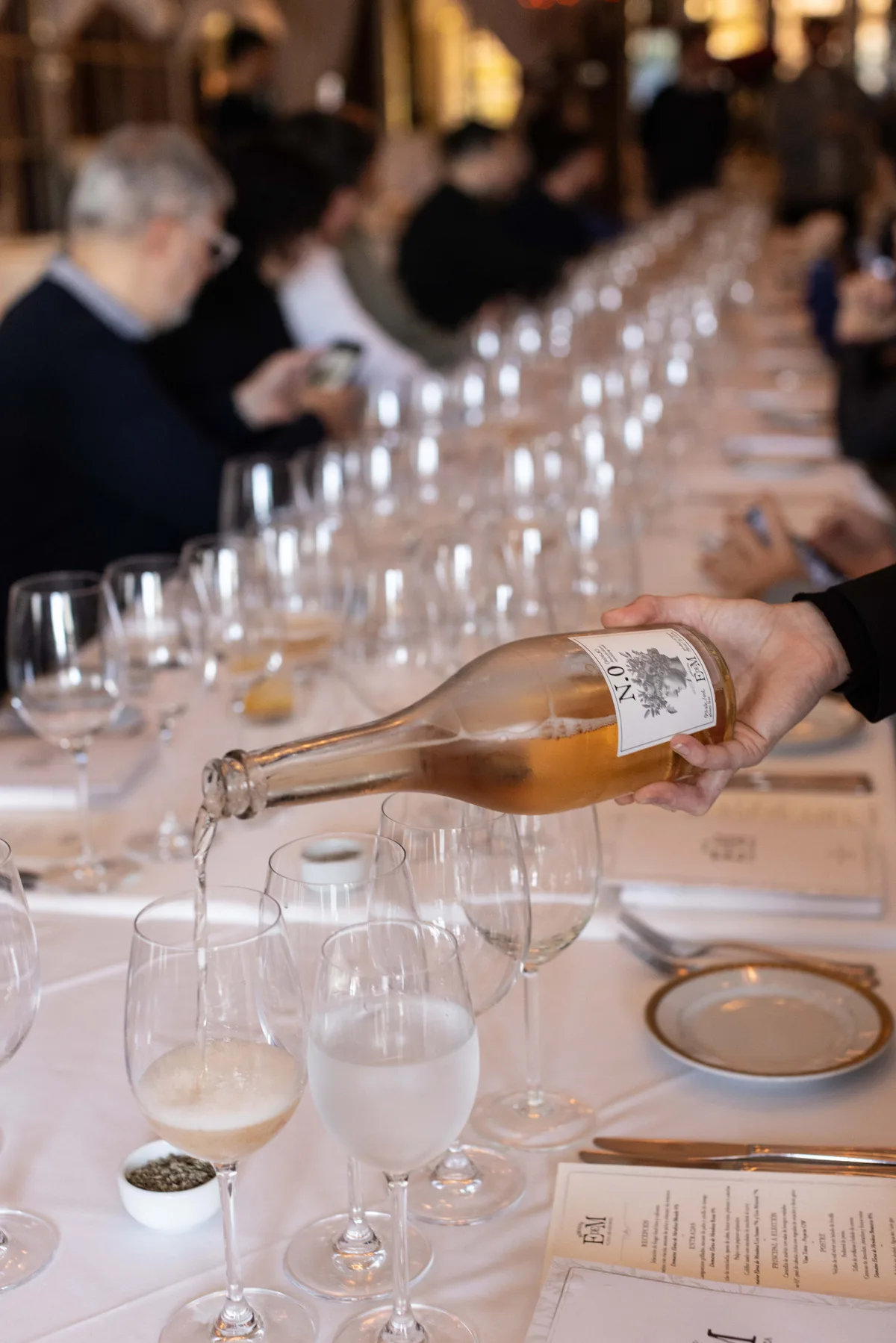 ROSAE being poured at a long tasting table